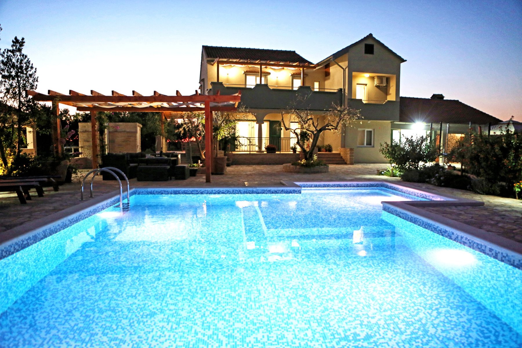 The villa and pool at dusk